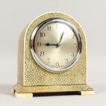 A SHAGREEN MANTLE CLOCK, EARLY 20TH CENTURY, with silvered circular dial, on ivory feet. 6ins high.