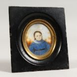 A 19TH CENTURY OVAL PORTRAIT MINIATURE, of a young girl wearing a blue dress. 5ins x 4.5ins.
