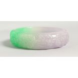 A GREEN AND LILAC JADE BANGLE. 3ins diameter.