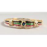AN IMPRESSIVE 18CT YELLOW GOLD BANGLE, set with ruby, sapphire, emeralds and diamonds.
