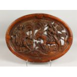 A GOOD EARLY OVAL PIERCED AND CARVED PANEL, depicting the Flight to Egypt. 24.5ins x 18ins.