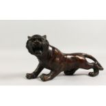 A JAPANESE BRONZE MODEL OF A TIGER. 12ins long.