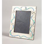 A LARGE ART DECO DESIGN SILVER AND BLUE ENAMEL PHOTOGRAPH FRAME, with blue scrolls. 11ins x 9ins.