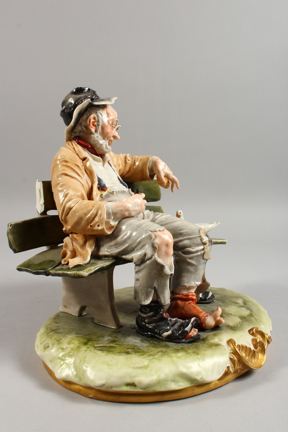 A CAPODIMONTE GROUP, a tramp seated on a bench, feeding two doves. 9ins wide. - Image 4 of 11