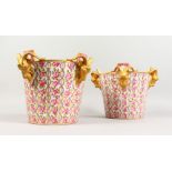 A VERY GOOD PAIR OF SEVRES PORCELAIN ICE PAILS, with bands of roses and four gilded rams masks.