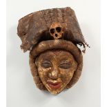 A CARVED AND PAINTED TRIBAL MASK, of a lady with alligator skin headdress. 16ins high.