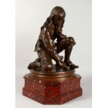 AFTER A. MOREAU VAUTHIER A GOOD BRONZE OF A SEATED BOY, drawing on the floor, on a rouge marble