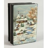 A RUSSIAN LACQUER BOX, decorated with a winter landscape with buildings. 3.5ins x 2.25ins.