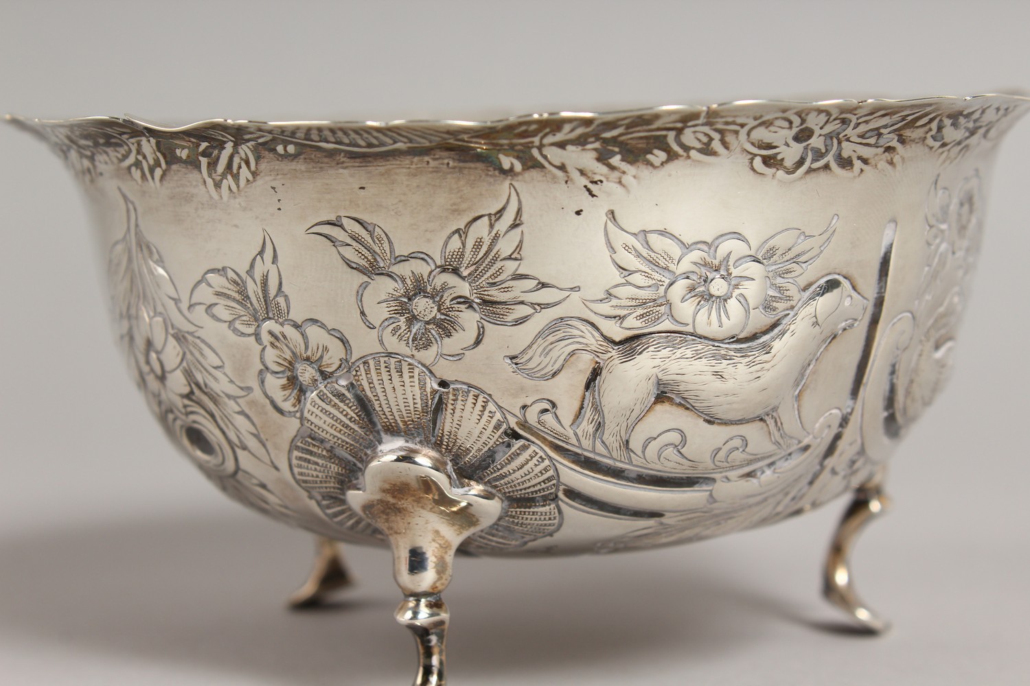 A VICTORIAN CIRCULAR SUGAR BOWL, repousse with birds, animals etc., on three pad feet. 4.75ins - Image 4 of 10