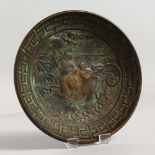 A CAST BRONZE CIRCULAR DISH. 5.75ins diameter.