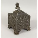 A HEAVY LEAD TOBACCO BOX AND COVER, decorated with a hunting scene. 7ins wide.