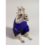 A NOVELTY SILVER PLATE AND BLUE GLASS CLARET JUG, in the form of a squirrel. 7ins high.