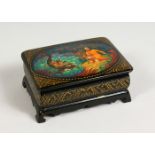 A RUSSIAN BLACK LACQUER BOX AND COVER, the lid with a classical scene. 4.75ins.