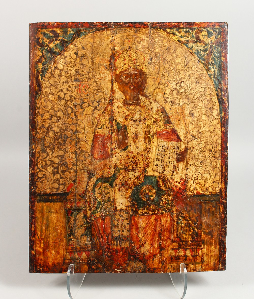 A VERY EARLY RUSSIAN ICON, on a wooden panel. Priest. 18ins x 14ins.