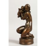 A SMALL CAST METAL GROUP, 20TH CENTURY, a young kneeling female nude holding an infant cupid. 7ins