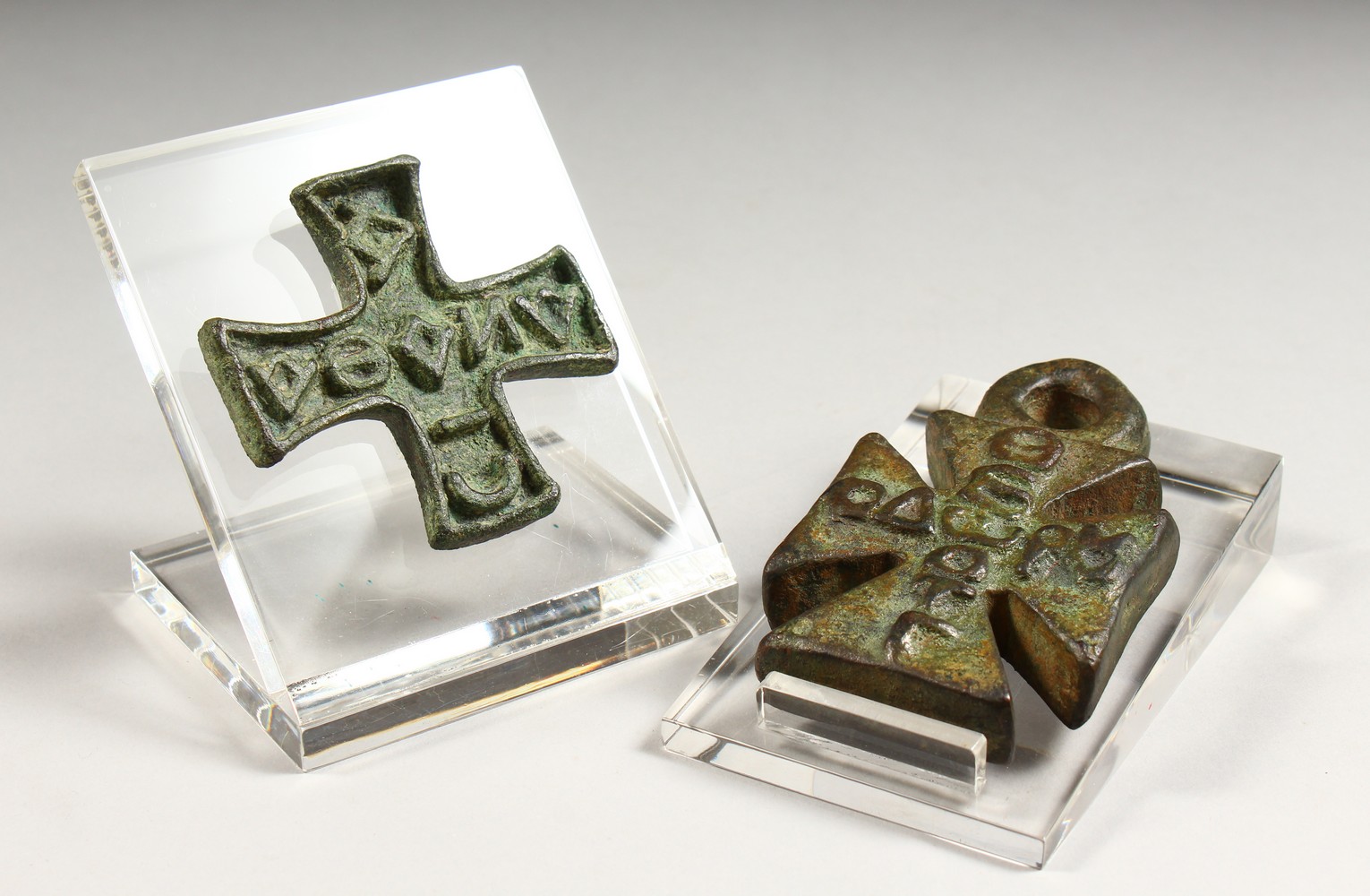 A BYZANTINE BRONZE CRUCIFORM STAMP and A BYZANTINE BRONZE WEIGHT. 4.5ins and 3.25ins.