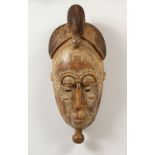 A WELL CARVED AFRICAN TRIBAL MASK. 17.5ins high.