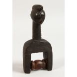 AN AFRICAN CARVED WOOD FIGURAL PULLEY. 6.5ins high.