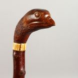 A WALKING STICK, the handle carved as a game bird. 38ins long.