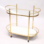 AN ART DECO STYLE TWO TIER OVAL SHAPED COCKTAIL TROLLEY. 2ft 10ins long.