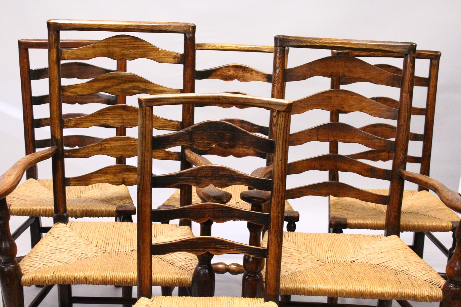A MATCHED SET OF SIX 19TH CENTURY ASH AND ELM LADDER BACK DINING CHAIRS, two with arms, with rush - Image 7 of 8