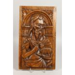 AN EARLY CARVED OAK PANEL, a male figure holding a lamb. 15ins x 8.75ins.