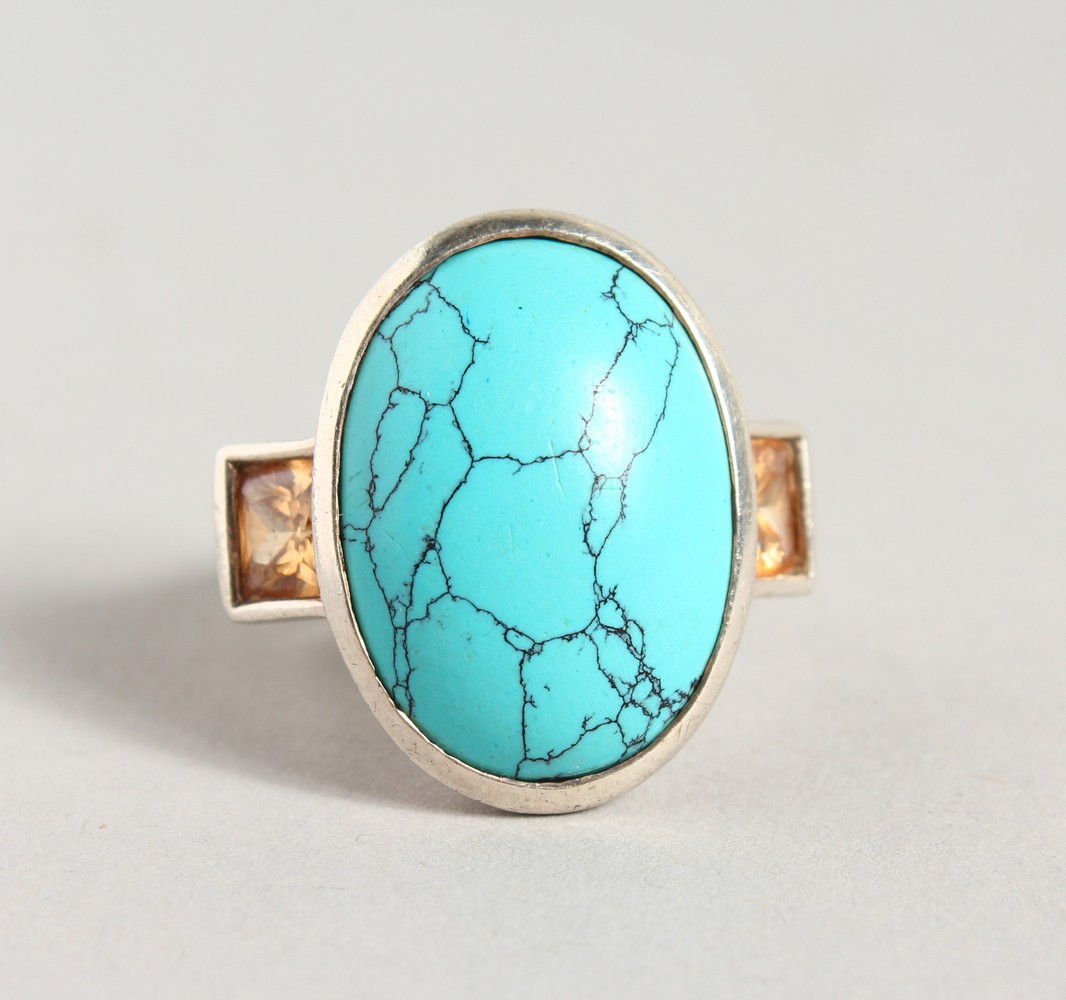 A STYLISH SILVER, TOPAZ AND TURQUOISE RING.