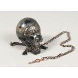 AN UNUSUAL SILVER TIMEPIECE, modelled as a skull, the top opening to reveal a watch dial and