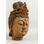 A CARVED AND PAINTED WOOD HEAD OF AN EASTERN FEMALE FIGURE. 16ins high.