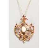 A 9CT GOLD OPAL AND RUBY PENDANT BROOCH on a chain.