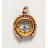 A HORSESHOE SHAPED BAROMETER PENDANT.