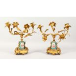 A PAIR OF 19TH CENTURY FRENCH GILT AND SEVRES PORCELAIN TWO BRANCH CANDLESTICKS. 10ins high.