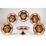 A SET OF FIVE ROYAL WORCESTER FRUIT PLATES and a COMPORT painted by R. Sebright (plates) and F.