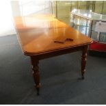 A VICTORIAN STYLE MAHOGANY EXTENDING DINING TABLE, by Frank Hudson & Son, with one leaf on turned