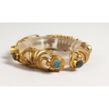 A RARE CRYSTAL AND GILT BANGLE set with eight hardstones. 4ins diameter.