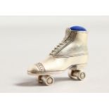 A CAST SILVER NOVELTY ROLLER SKATE PIN CUSHION.