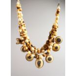 A GOOD NATIVE IVORY NECKLACE, seven various shaped ivory medallions hung from a double and single