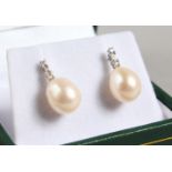 A PAIR OF 9CT GOLD PEARL AND DIAMOND EARRINGS.