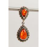 A SILVER AND AMBER DOUBLE PENDANT.