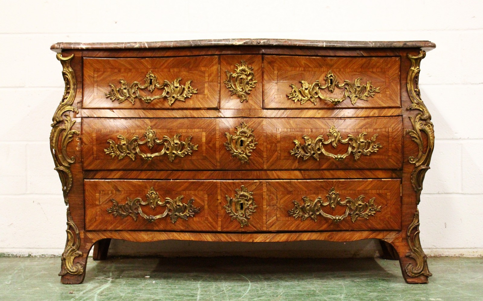 A LOUIS XVTH KINGWOOD BOMBE FRONTED COMMODE by JEAN CHARLES ELLEUME, CIRCA 1755, with grey marble