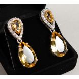 A PAIR OF SILVER AND CITRINE PEAR SHAPED DROP EARRINGS.