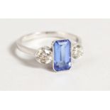 AN 18CT GOLD BAGUETTE DIAMOND CUT SAPPHIRE AND DIAMOND RING.