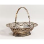 A GEORGE III OVAL PIERCED BASKET with gadrooned edge, garland, pierced sides and swing handle. 12.