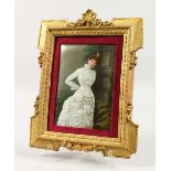 A GERMAN PORCELAIN PLAQUE, three quarter length iof a young lady in a white dress. 6.5ins x 4.5ins