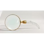 A BRASS MAGNIFYING GLASS with cut glass handle.