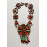 A LARGE ROMAN TYPE CORAL, ENAMEL AND SILVER NECKLACE set with a large circular pendant, 4ins