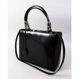 A CHRISTIAN DIOR BLACK PATENT BAG.