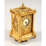 A GOOD FRENCH GILDED CLOCK with pierced panels and elephant supports. 6.5ins high.