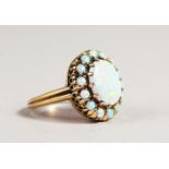 A 9CT GOLD OVAL OPAL CLUSTER RING.