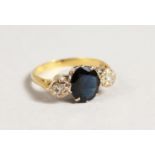 AN 18CT GOLD, SAPPHIRE AND DIAMOND THREE STONE RING.